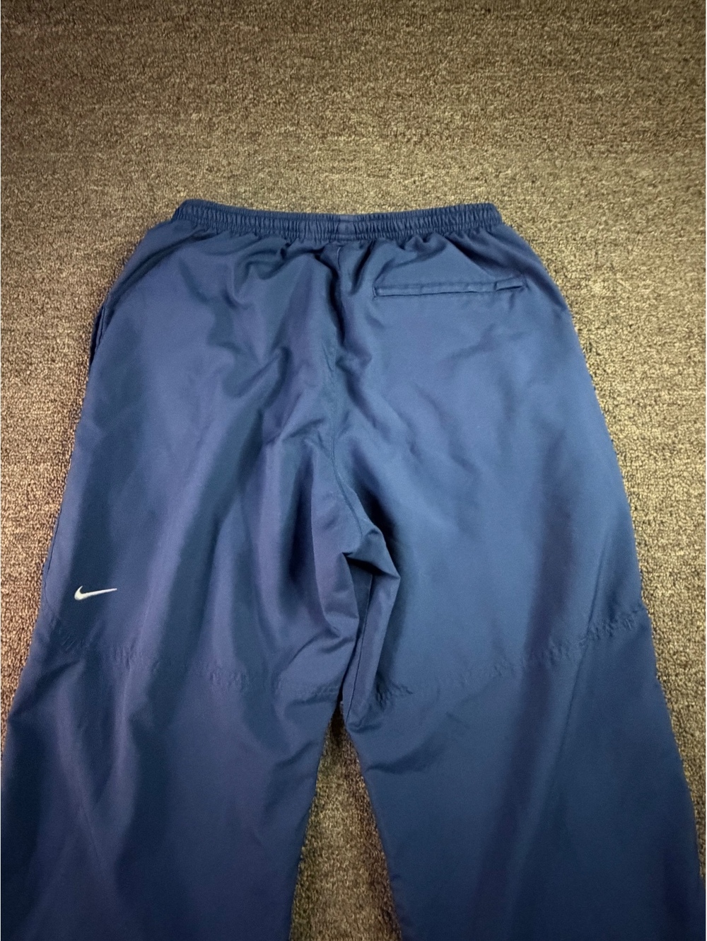 Vintage Nike Team men’s track pants in navy blue, size Large.